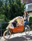 A woman with children ridign a Bakfiets Long Cruiser cargo bike