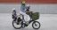 A woman with 2 children on a Bicicapace Classicona cargo bike