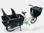 A green Bicicapce Justlong cargo bike with childpack