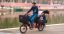 A man with children riding a Bicicapace Justlong cargo bike