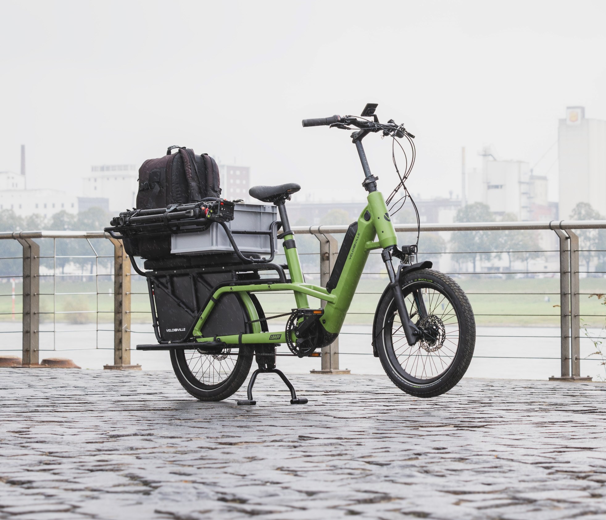 A green Velo De Ville Loady bike on the waterfront