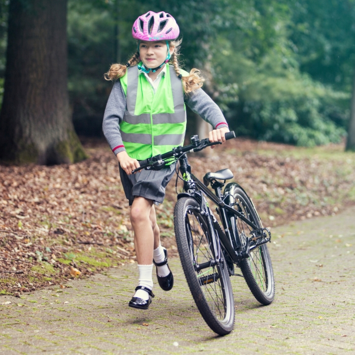 A girl pushing a Frog 67 bike