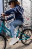A child on a teal Frog City 53 bike