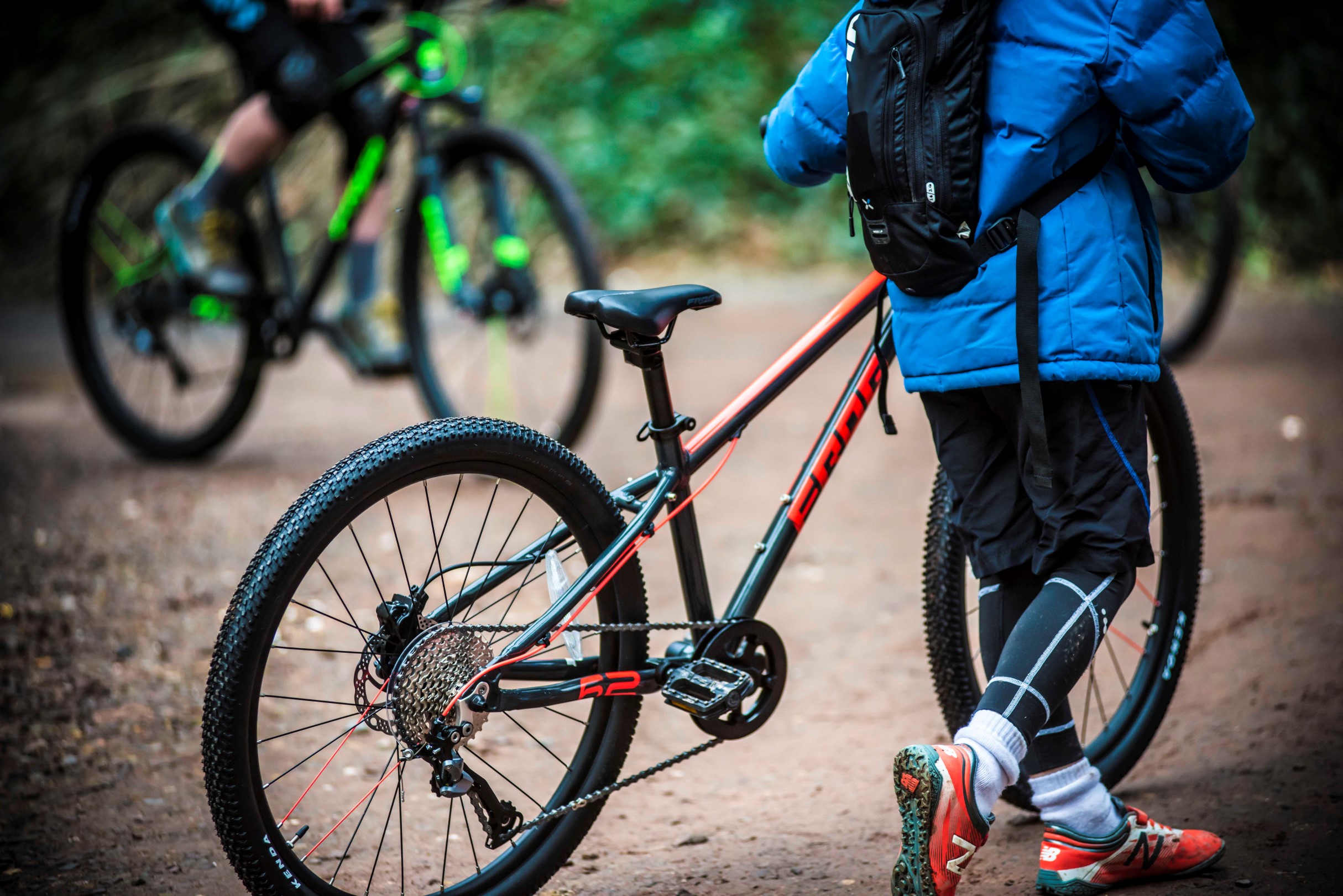 A kid pushing a Frog Mountain 62 bike