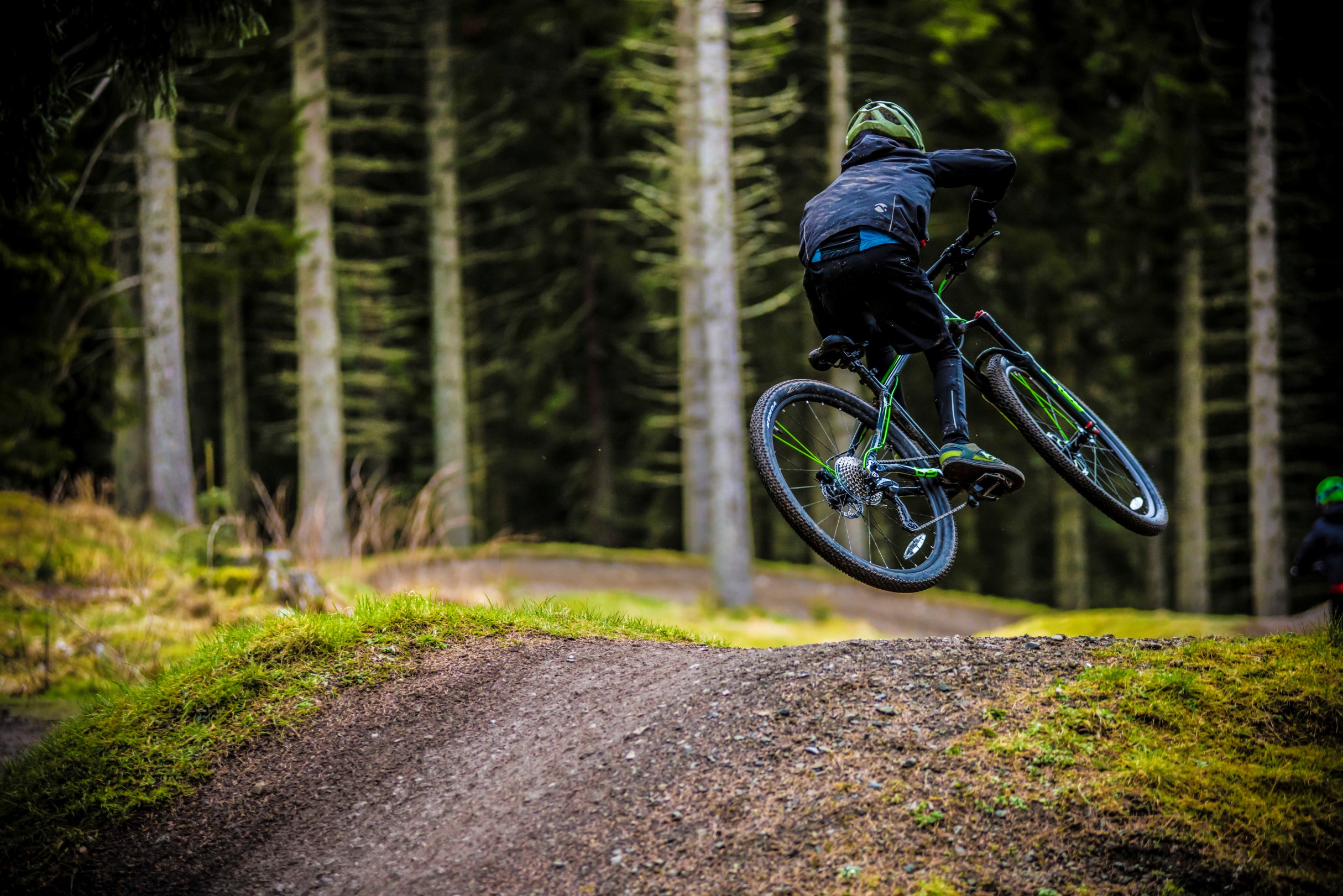 A boy jumping a tabletop on a Frog Mountain 69 bike