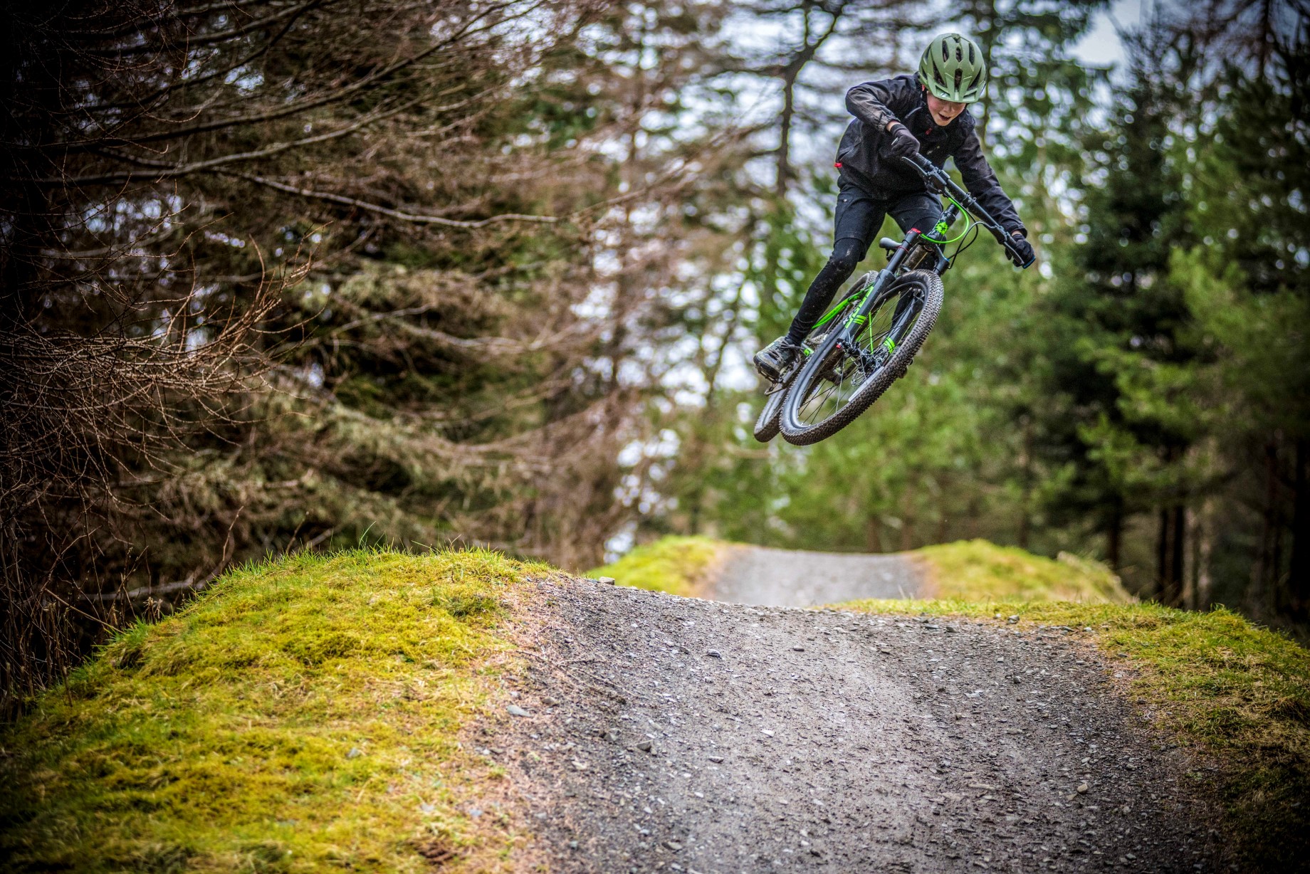 A boy jumping a tabletop on a Frog Mountain 69 bike