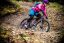 A girl riding a berm on a Frog Mountain 72 bike